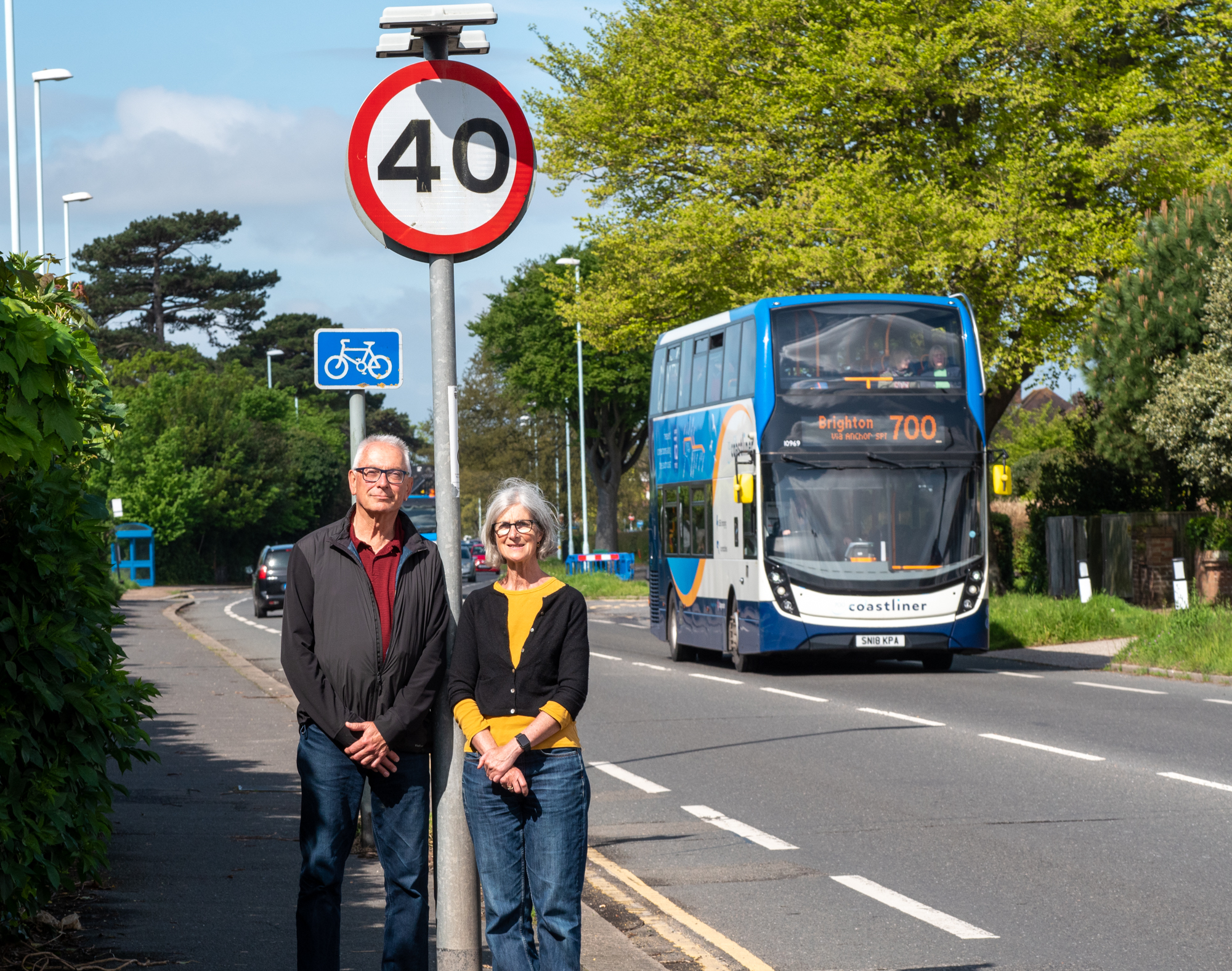 Claire Hunt and Ian Davey stand in front of a 40 mph sign on Goring Road